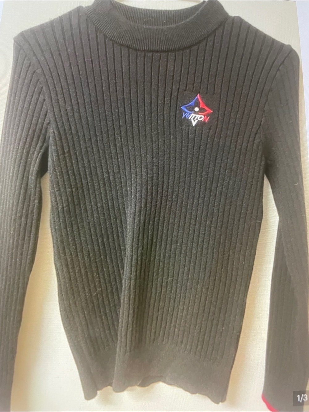 Louis Vuitton Womens Black Ribbed Turtleneck Sweater with Subtle Chest Emblem